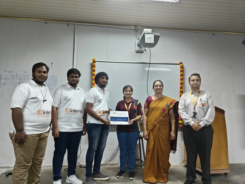 A student receiving a certificate alongside the Aishwi team and college representatives